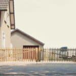 Dubbele Franse rondhoutpoort van kastanjehout van 50 cm hoog en 200 cm breed per poortdeel. De poort wordt gebruikt als doorgang naar de parkeerplekken bij de woning.