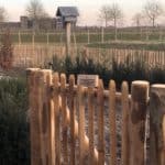 Franse rondhoutpoort van 80 cm hoog en 80 cm breed als doorgang in een tuin.